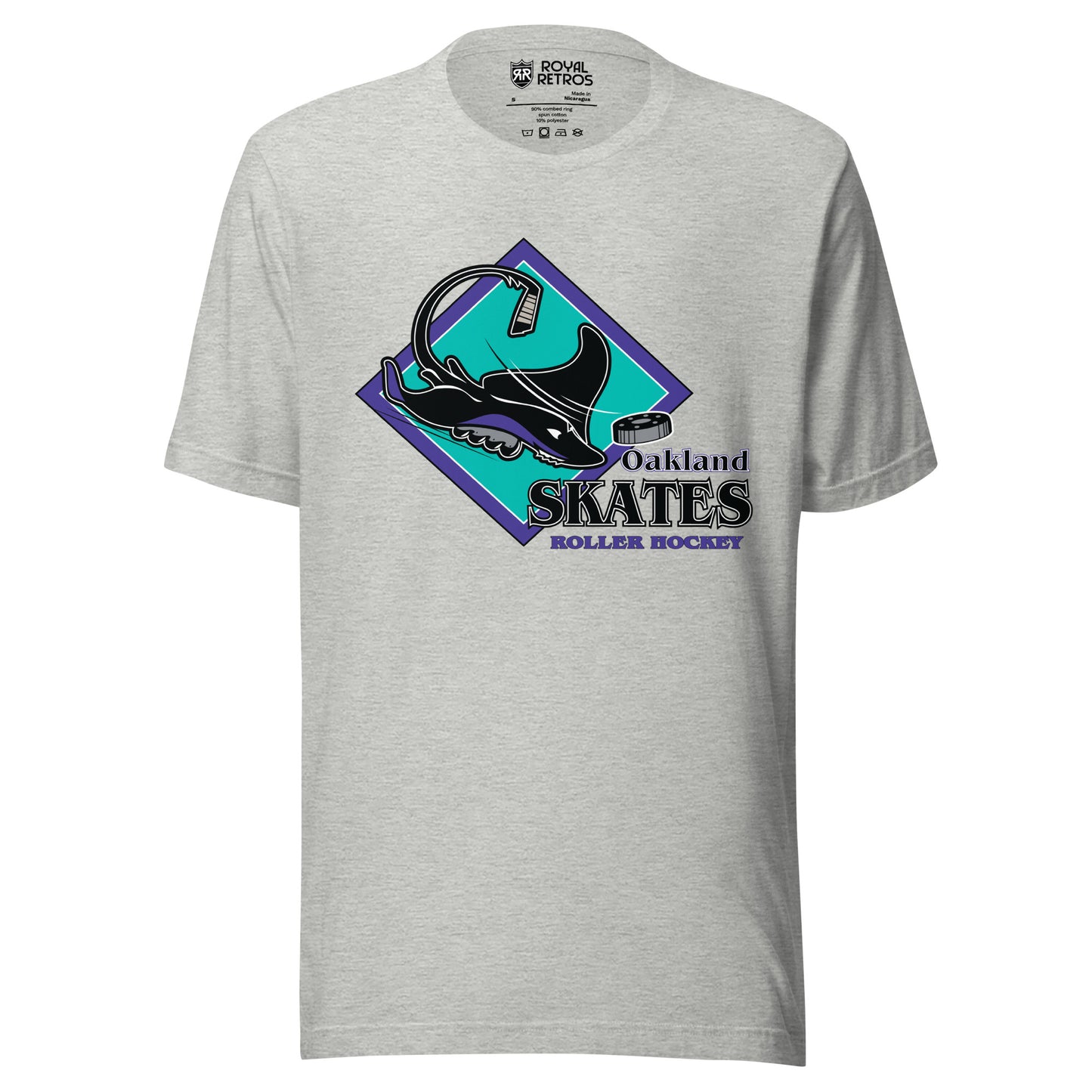 Oakland Skates roller hockey T-Shirt. Athletic Heather. Aqua diamond with purple trim. Manta Ray swimming tom the right over diamond. To the right, Oakland small over Skates large, purple with white lining, Roller Hockey smaller in purple. Royal Retros