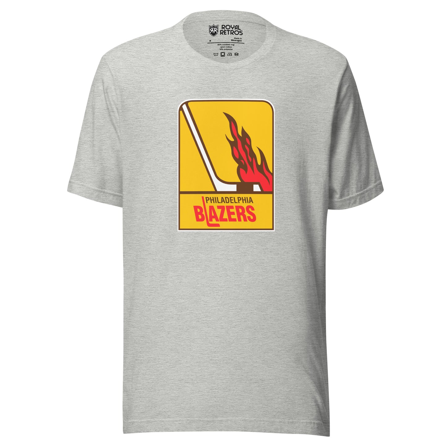 Philadelphia Blazers WHA T-shirt. Light Gray. Logo is vertical gold rectangle. Hockey stick in white facing right. Flames above the blade. Philadelphia in black small above Blazers larger in red. L is a hockey stick Royal Retros