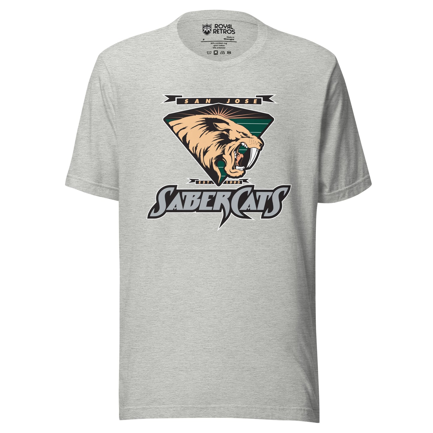 San Jose Sabercats Arena Football League T-shirt gray. San Jose in gold in small black banner, waving at ends, Above upside down triangle shield with sabertooth tiger facing right. Stylized SABERCATS in blue on black background with white trim below. Royal Retros