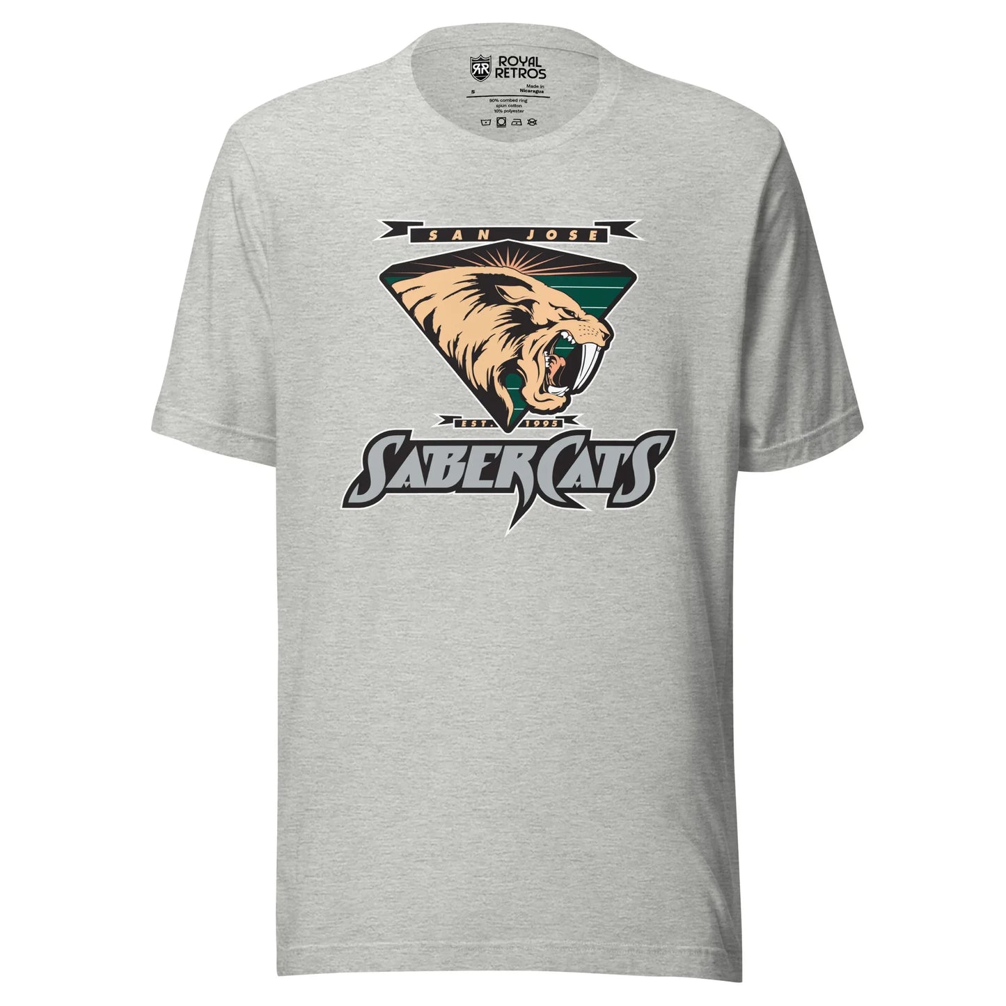 San Jose Sabercats Arena Football League T-shirt gray. San Jose in gold in small black banner, waving at ends, Above upside down triangle shield with sabertooth tiger facing right. Stylized SABERCATS in blue on black background with white trim below. Royal Retros