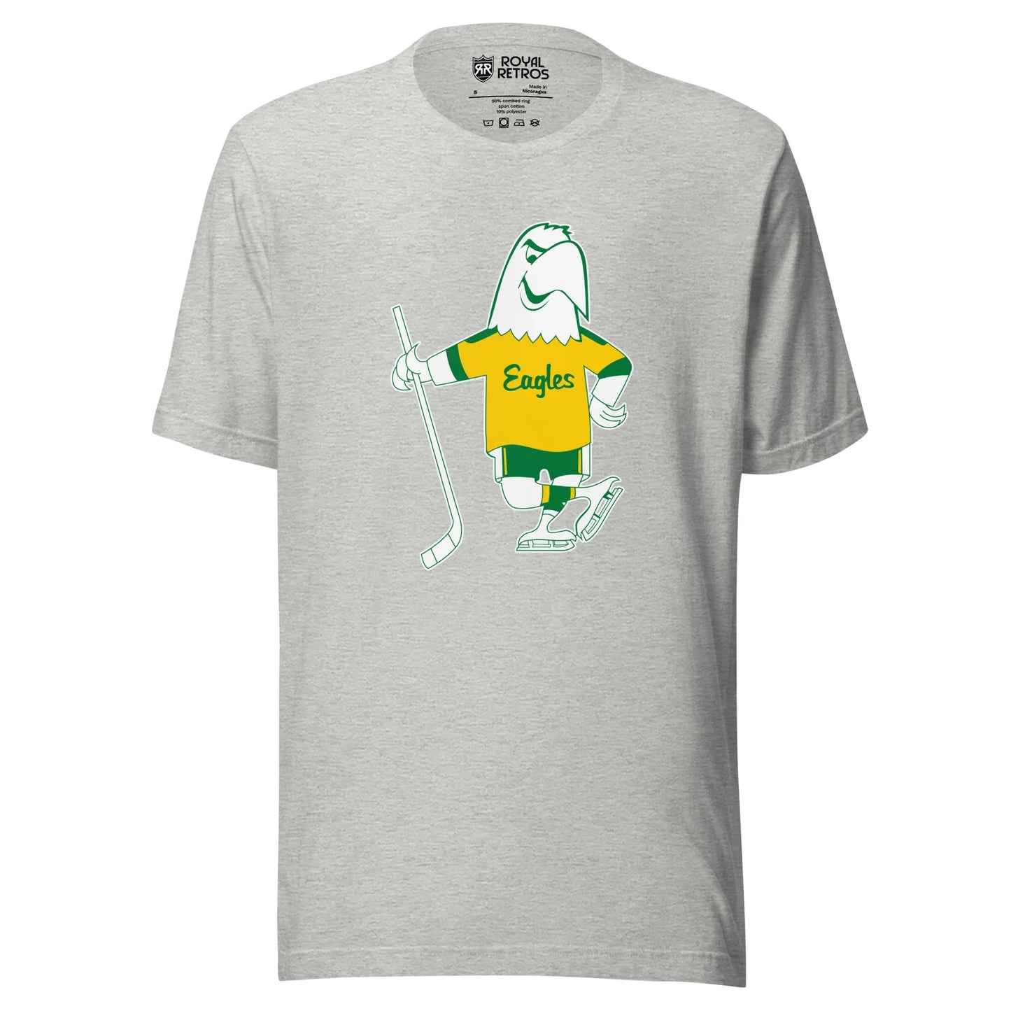 Salt Lake Golden Eagles Hockey T-shirt. Gray. Cartoon white Eagle drawn in green wearing a gold jersey with Eagles in script across chest. Green sleeve ends on Eagle's jersey. Green shorts with yellow stripes. Wearing white skates and holding a hockey stick in his right wing. Royal Retros.