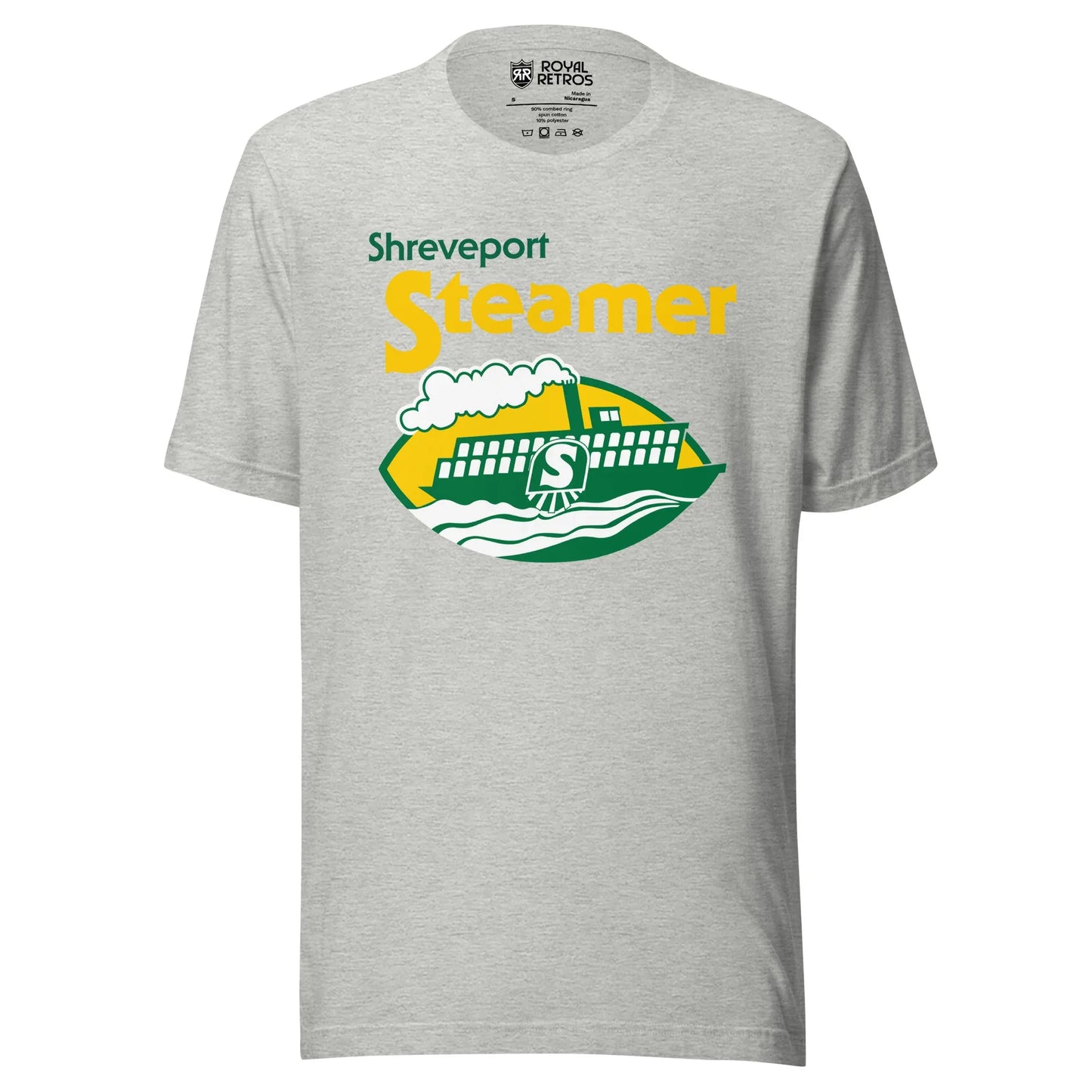 Shreveport Steamer World Football League T-shirt. Gray. Shreveport in green small, upper left. Steamer large in yellow below that centered. Logo below is a cartoon paddle wheel steamer with an S on the wheel. on green and white waves on a football shaped background. Royal Retros