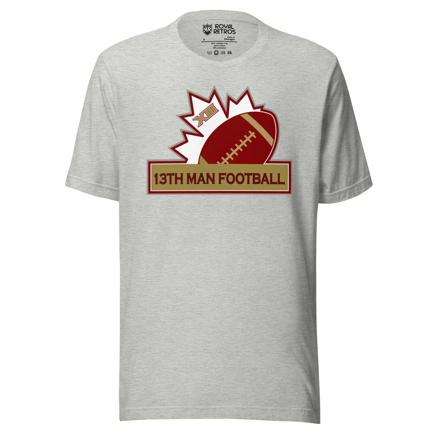 13th Man football T-shirt. Gray. Top of white maple leaf tilted left. Football leaning right. Gold box below with red trim with 13th Man Football in red inside. Royal Retros