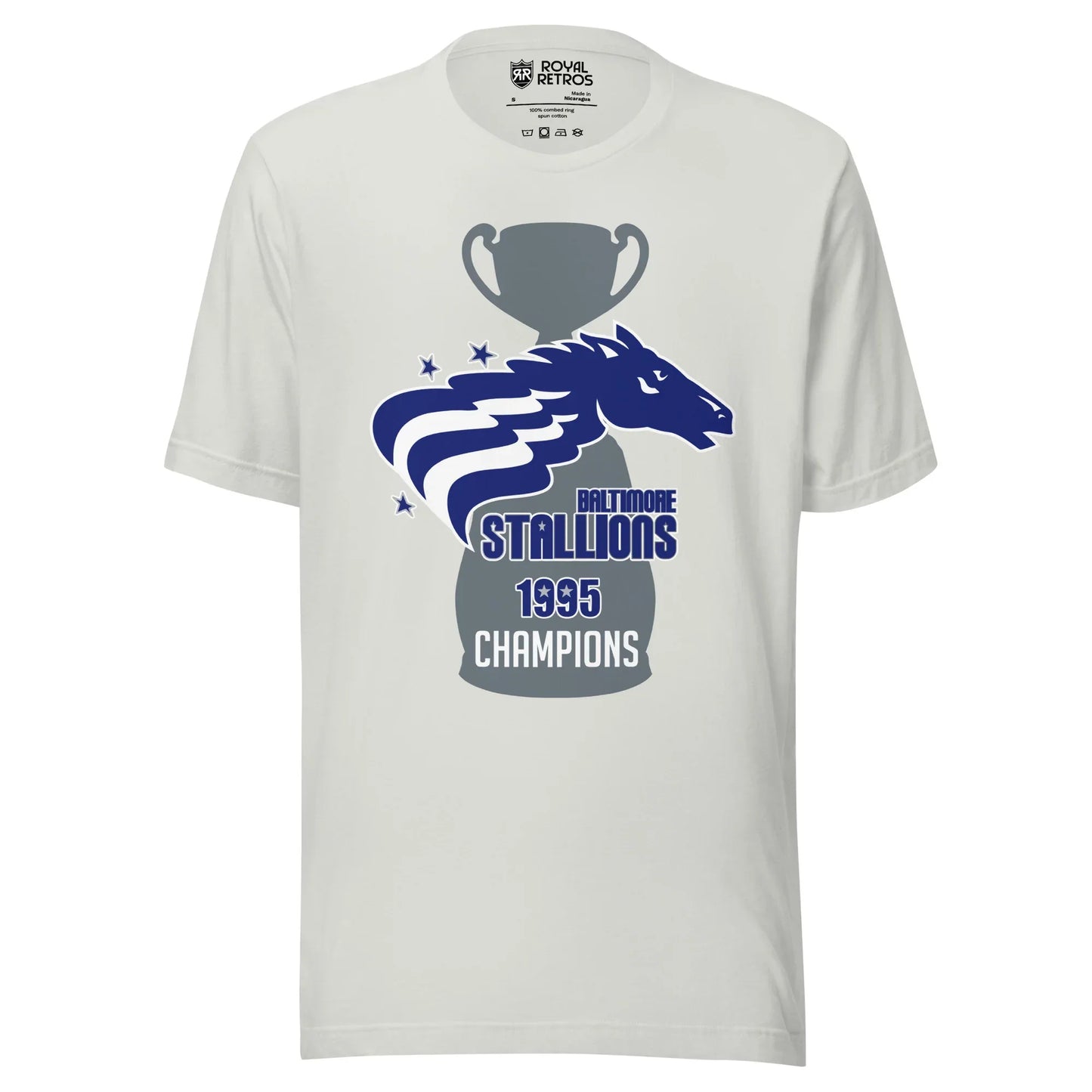 Baltimore Stallions Championship T-short. Silver. Large gray trophy with large base. Over top is a horses head in blue facing right. Two white wavy stripes from its mane. Two blue stars upper left, one lower left. Baltimore below right in blue. Stallions in blue big below. 1995 below in blue. Champions in white below that. Royal Retros