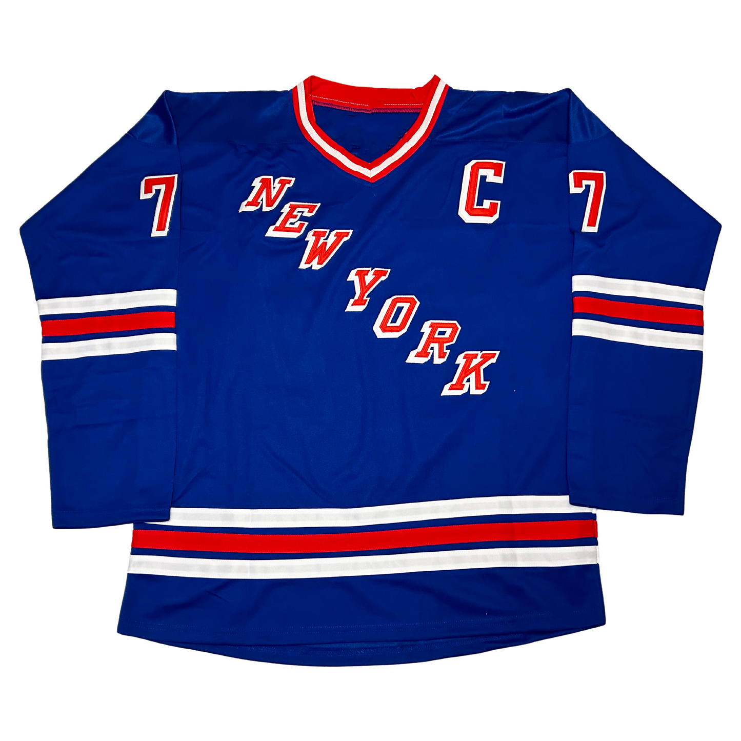1980 New York Rangers jersey. Blue. Red, white, red collar. Captain's C upper left chest red with shadow white. White, red, white stripes mid-sleeve and above waist. New York diagonal down left to right, red with white shadow. Royal Retros.