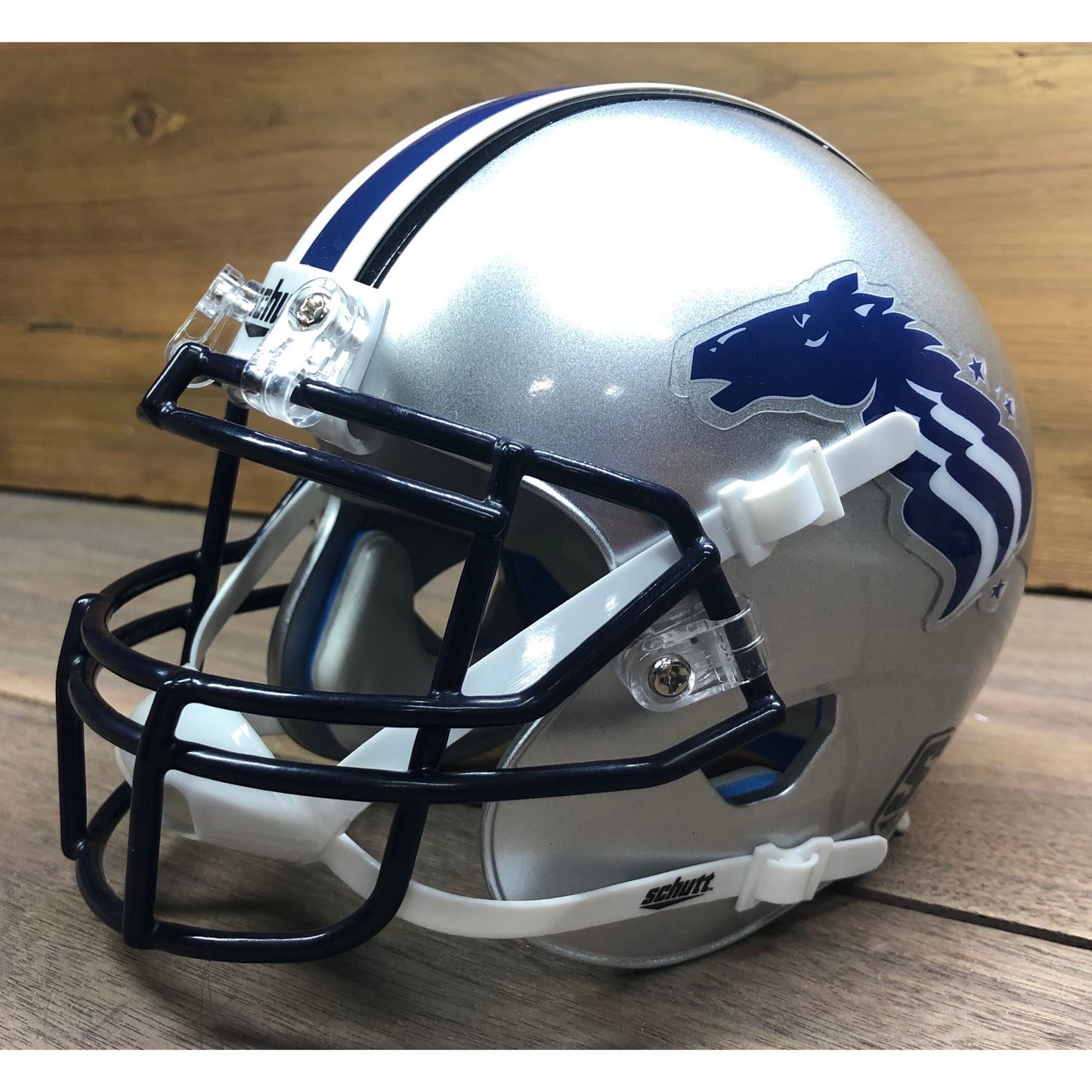 Baltimore Stallions Mini Helmet silver with blue horse head logo with white stripes trailing down mane. Blue facemask, blue, white, and blue stripe across top. Royal Retros