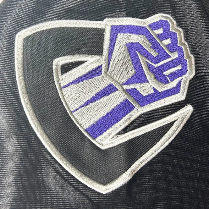 Chicago Enforcers XFL Jersey close-up logo which is a C with a silver and purple fist emerging from the letter. Royal Retros