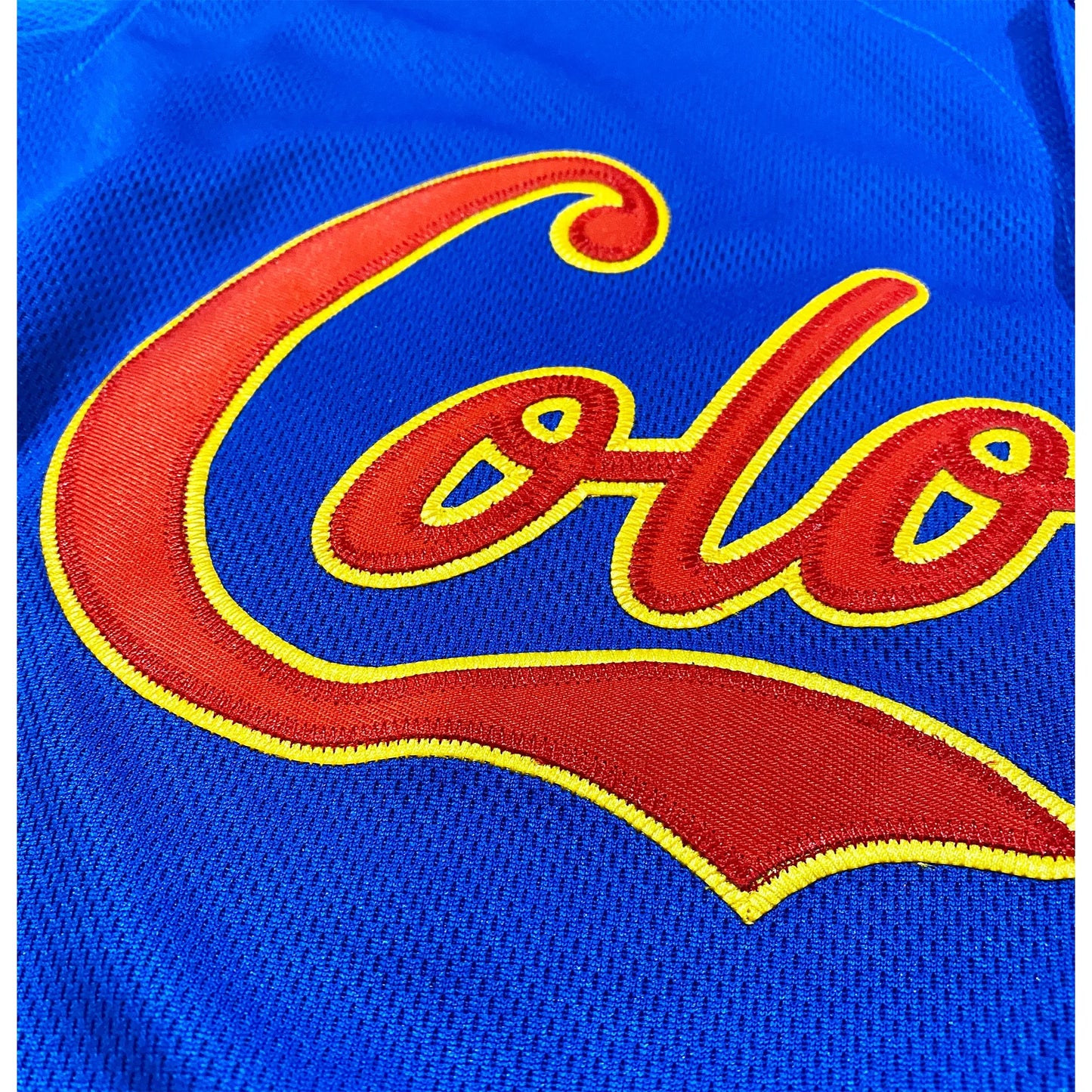 Blue fabric Colombia Baseball Jersey with embroidered red and yellow lettering