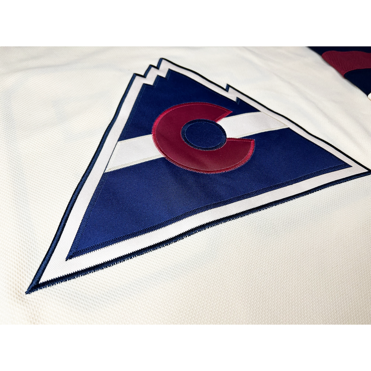 Colorado Rockies Cream Collection Jersey close-up of mountain with C logo. Royal Retros