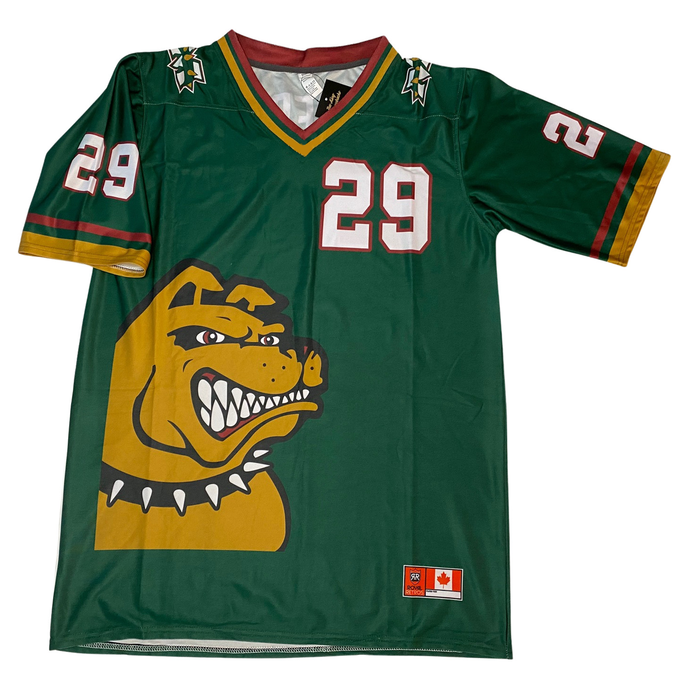 Memphis Mad Dogs Jersey green. Gold dog head, growling, with spiked collar, lower left. #29 white with red trim upper right chest and sleeves. Red, green, and gold collar, and trim at sleeve ends. Royal Retros