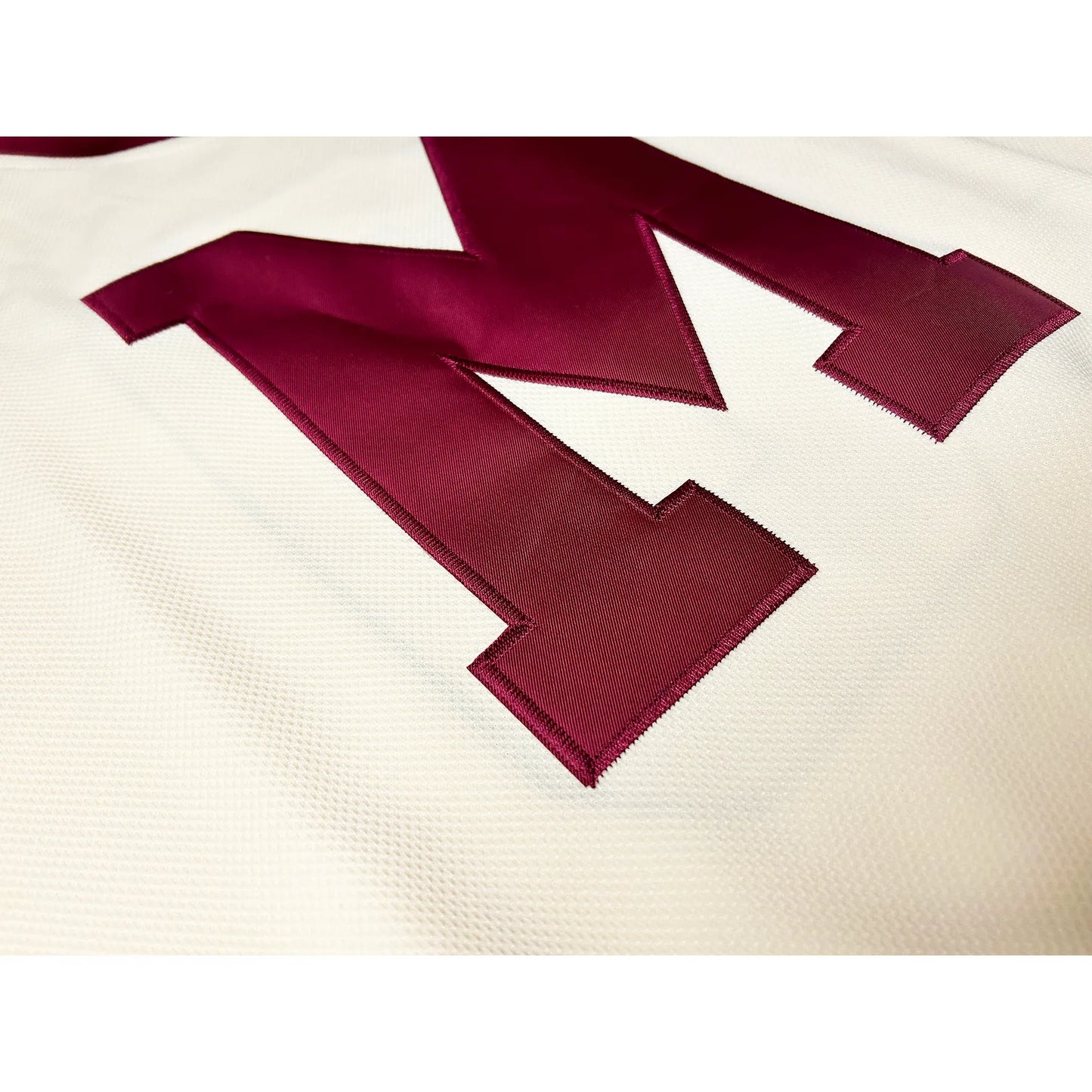 Close up of maroon M on Montreal Maroons cream jersey. Royal Retros