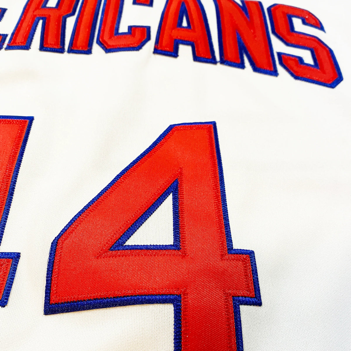 New Jersey Americans Jersey. White. Close-up of stitched "AMERICANS" lettering and numeral in red twill with blue outline.