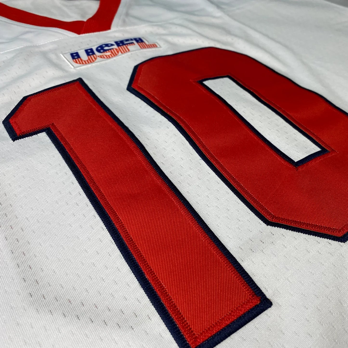 New Jersey Generals USFL Remix Jersey white with red number 10 and USFL logo Royal Retros