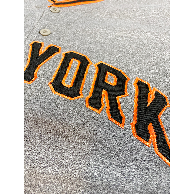 New York Giants baseball jersey close up of York in black with orange trim on pepper gray. Royal Retros
