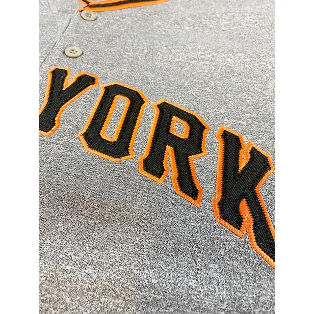 New York Giants baseball jersey close up of York in black with orange trim on pepper gray. Royal Retros