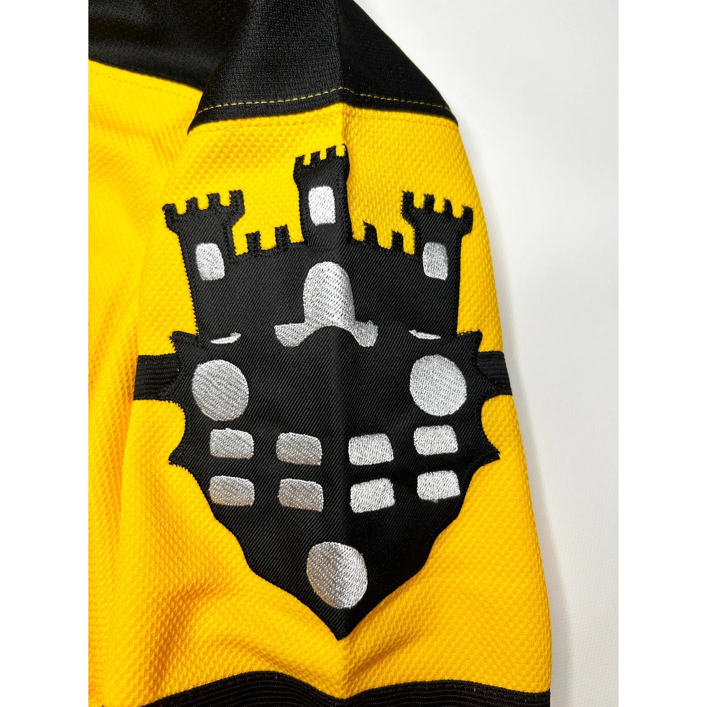 Pittsburgh Hockey Pirates Jersey gold with black trim close-up of city of Pittsburgh shield, black with white detail. Royal Retros