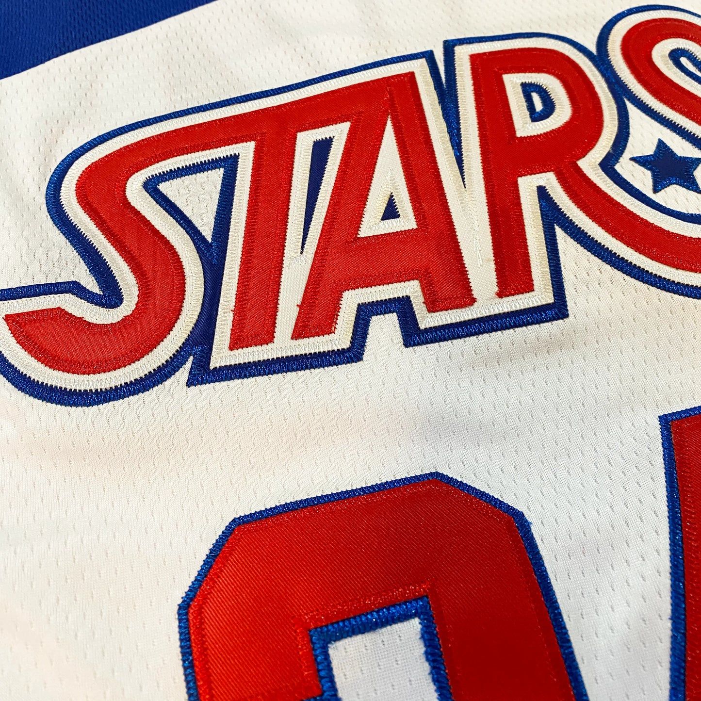 White Utah Stars Jersey featuring red and blue lettering for hockey fans