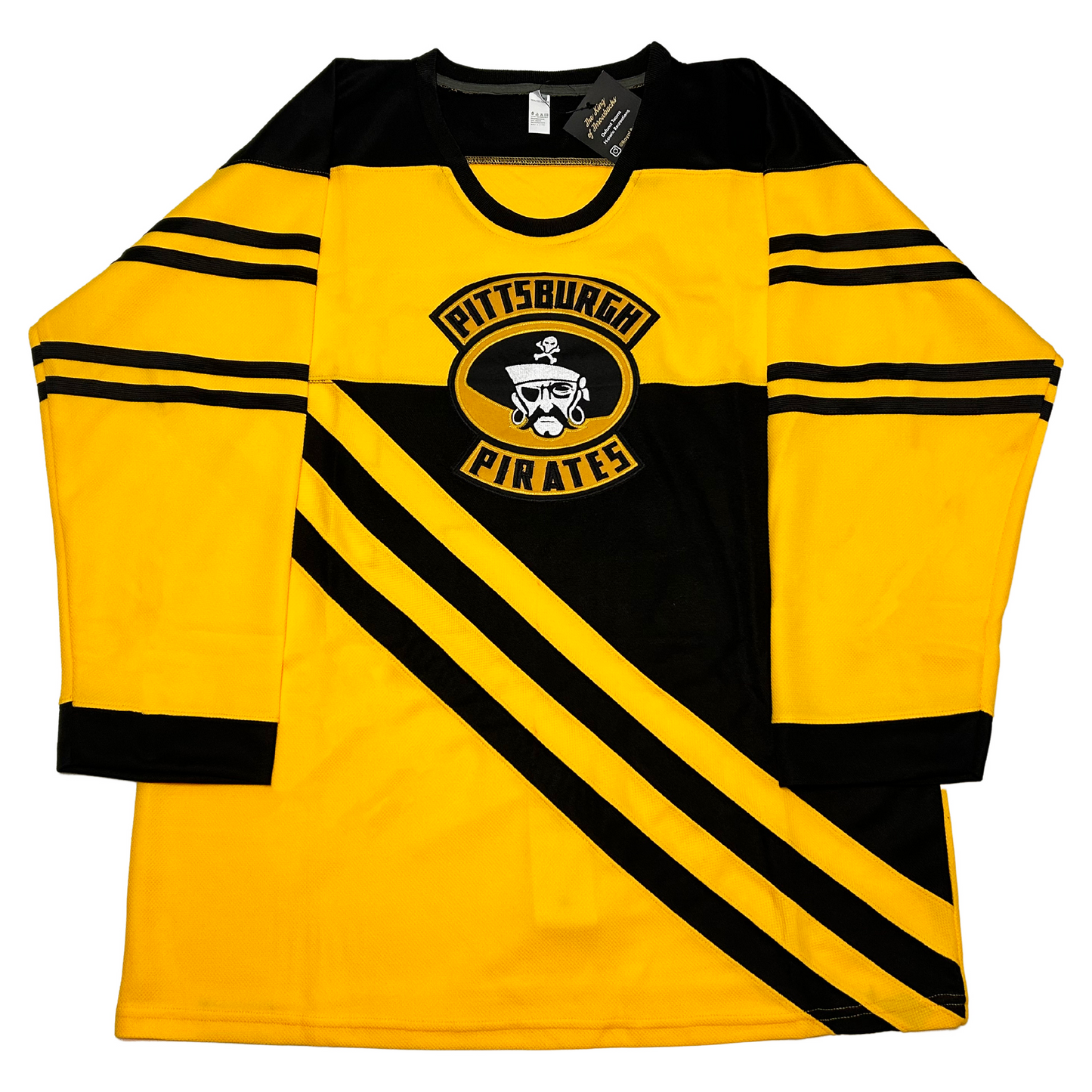 Pittsburgh Hockey Pirates Jersey. Gold. Black shoulders and neck. Two separate sets of black stripes on sleeves. Black trim on sleeve ends. Two diagonal black stripes just below chest going upper left to bottom right. Black triangle paralell to stripes. Pittsburgh Pirates logo with pirate face centered on upper chest. Royal Retros