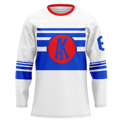 Omaha Knights hockey jersey white. Red collar. Four blue bands mid sleeve increasing in size. Four blue bands on chest increasing in size. Blue circle over bands, with red background and interlocking AK in blue inside. Royal Retros