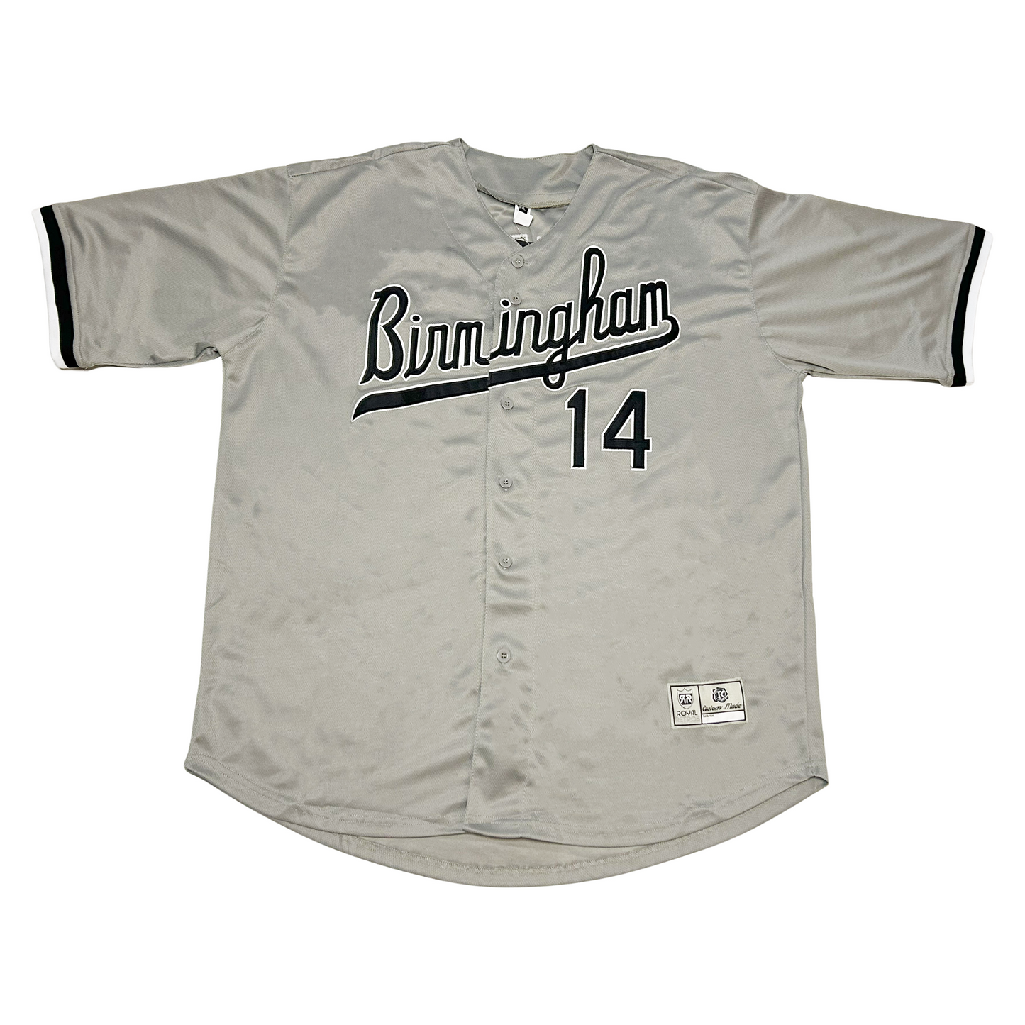 Birmingham Barons button-up baseball jersey. Gray. BIRMINGHAM in cursive, black with white trim and text tail coming off M. #14 lower right, black with white trim. Black trim on sleeve ends. Royal Retros