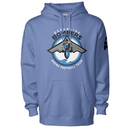 Oceanside Bombers football hoodie. Carolina blue. Oceanside in white arched above Bombers slightly larger in black over a circle outlined in black and two slightly larger rings, blue and light blue inside. White background. B-2 bomber from the top over the circle with wings slightly protruding. A football coming off the tail. An ocean wave appears in the bottom of the circle. Outside the circle arched below is Arena Football team arched up in white. Royal Retros