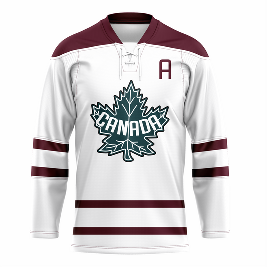 Winnipeg Maroons Canada Team hockey jersey. White. Maroon collar. Maroon bands around middle of sleeves and above waist. Large blue and white maple leaf on chest, with Canada in white arched up inside. Co-Captain A in maroon on left chest. Royal Retros