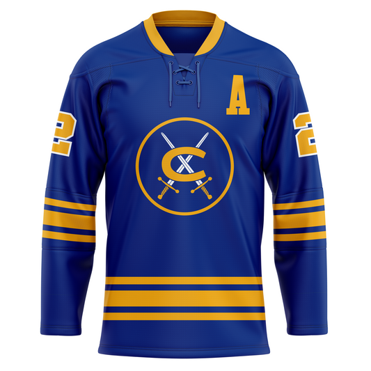 Cincinnati Swords hockey jersey. Blue. Gold collar, Thin gold, thin blue, thick gold, thin blue, thin gold bands two-thirds of the way down sleeves and above waist. Numbers in gold with white trim on shoulders. Co-captain A on left chest. Logo in center is a gold circle with two crossed swords with gold handles and a gold C over top. Royal Retros