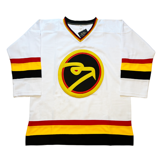 Louisville Icehawks hockey jersey white. Black, red, and gold collar. Red, gold, and black bands, mid-sleeve and around waist. Logo is stylized hawk head in gold circle, with red trim inside and black background. Head is gold with red eye. Royal Retros