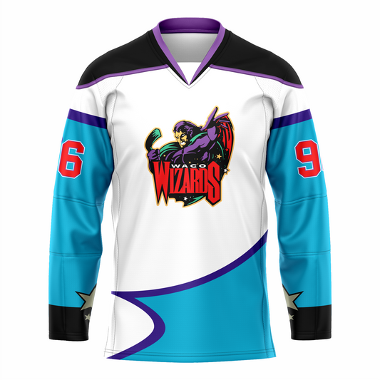 Waco Wizards hockey jersey white. Black shoulders with purple trim. Purple and black collar, Bottom half of sleeves and waist are light blue with purple trim. Logo is a purple wizard holding a hockey stick. Waco small in white above WIZARDS in red, Royal Retros