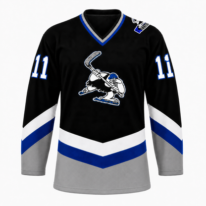 B.C. Icemen hockey jersey front in black with grey lower body, blue and white chevron striping, and the cartoon penguin mascot crest at center chest