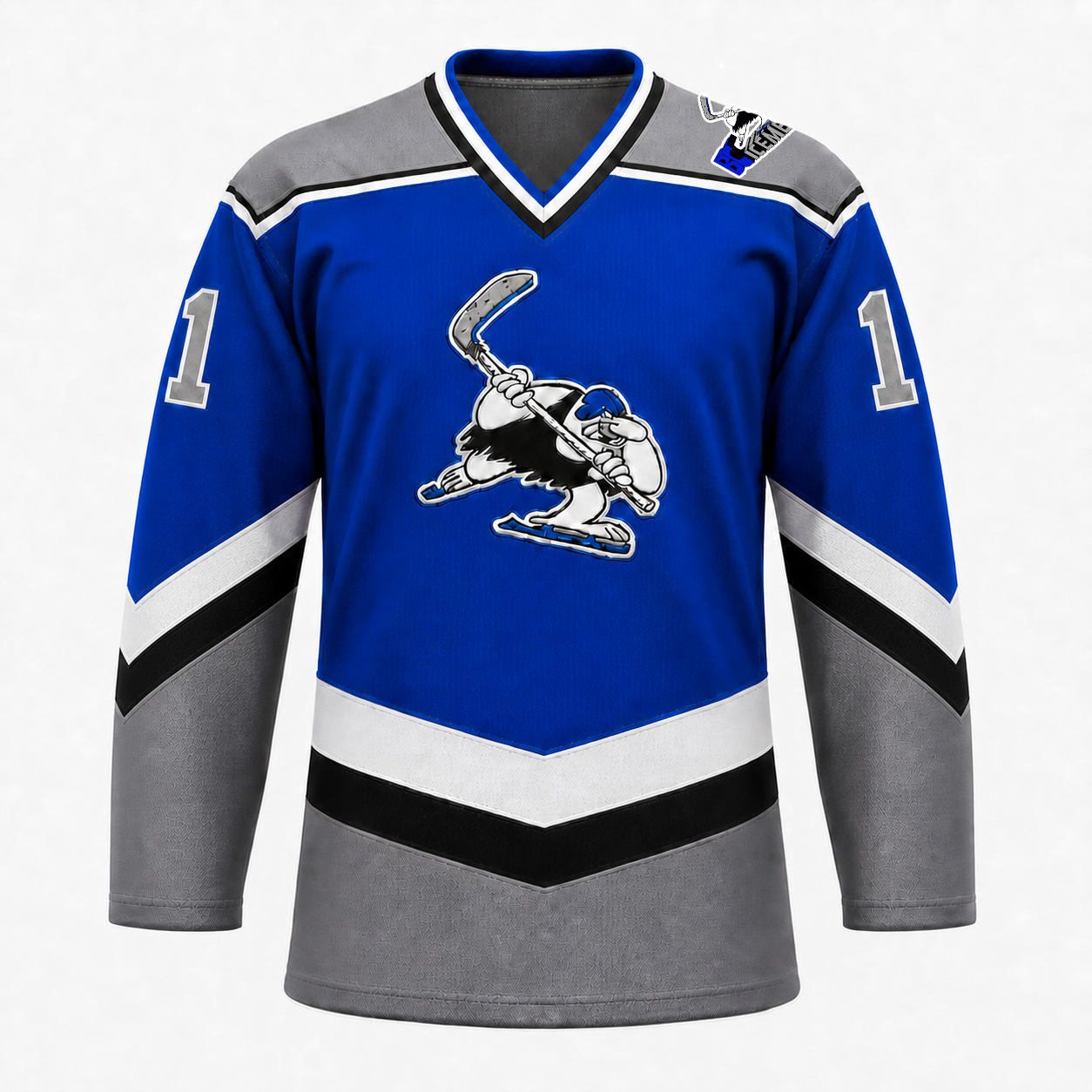 B.C. Icemen hockey jersey front in royal blue with grey shoulders and lower body, black and white chevron striping, and the cartoon penguin mascot crest at center chest