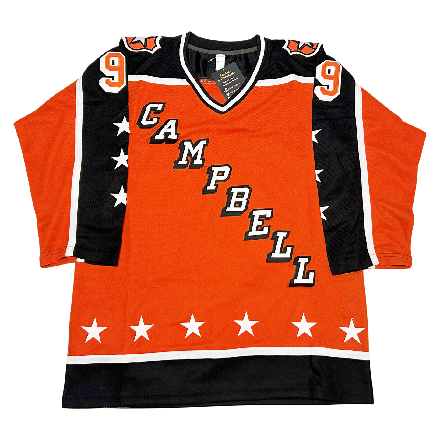 Clarence Campbell Conference All-Star jersey. Orange. Half black, half orange sleeve separated by a white band. Three white stars on black part. Black shoulders with white trim. "CAMPBELL" in white with black shadow diagonal left down to right. Black band with white trim at waist with six white stars above. #9 orange with white shadowing on black part of upper sleeves. Royal Retros