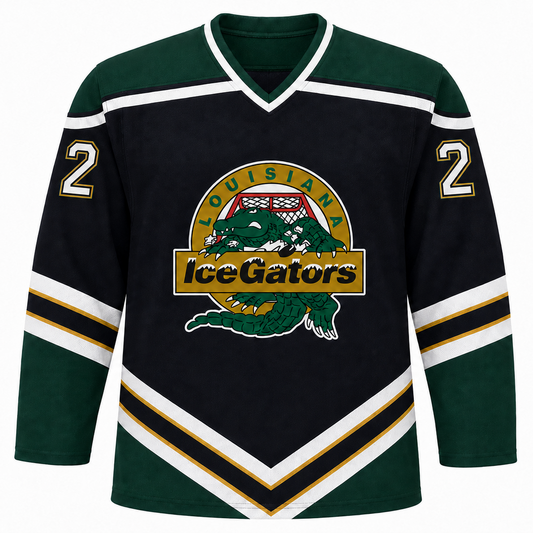 Louisiana IceGators hockey jersey. Black body with dark green shoulders and sleeves. White and gold chevron stripes angled from mid-chest down to the waist and banded around each sleeve. White V-neck collar with green trim. Gold number 2 on each shoulder. IceGators crest on the center chest: a green alligator on a gold circle, LOUISIANA arced above, IceGators across a gold banner. Royal Retros