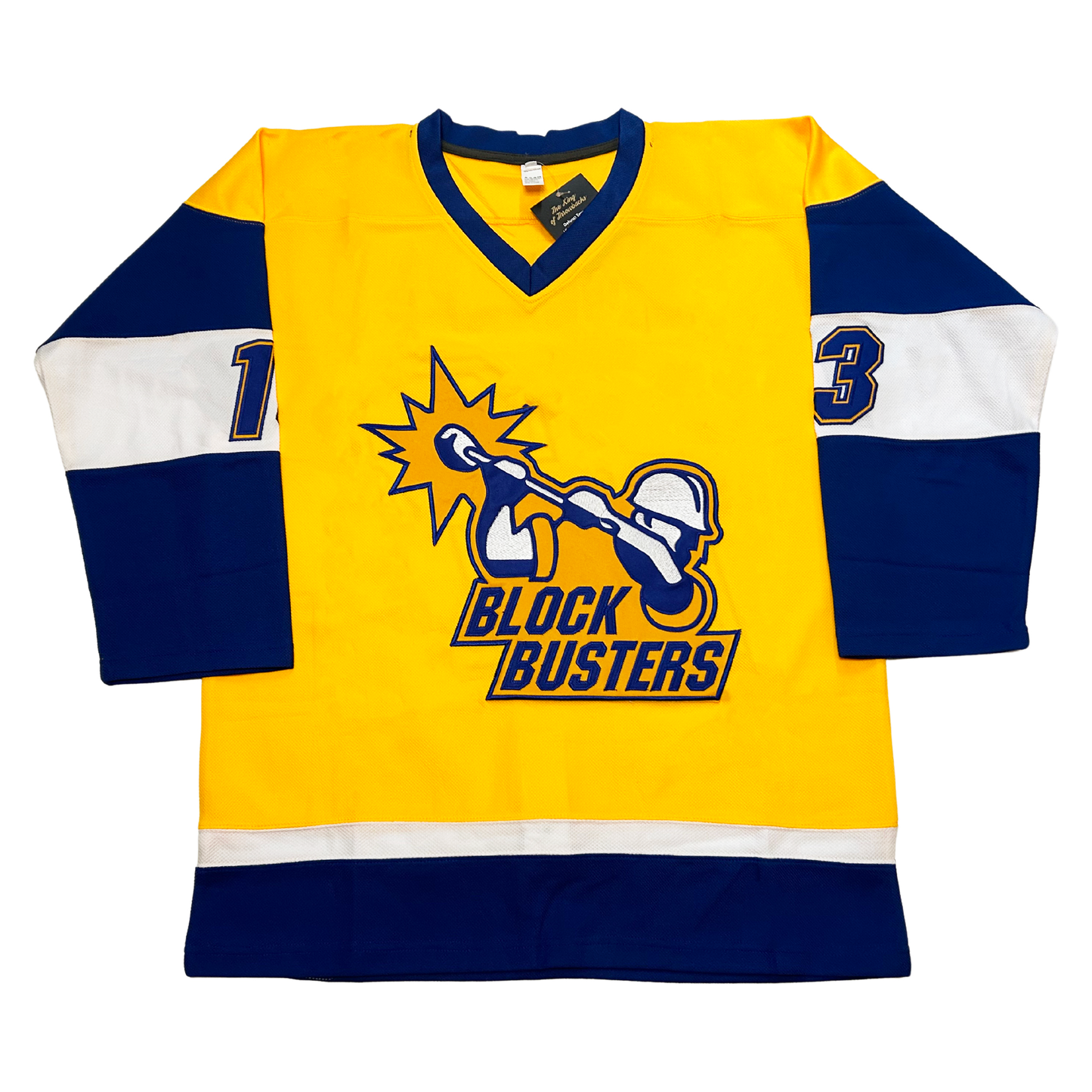 Florida Block Busters hockey jersey. Yellow with blue collar. Blue sleeves with thick white band mid-sleeve. #13 blue with yellow trim in band. White and  blue band above waist. Logo in center of construction worker, chest-up, in gold with blue and white detail swinging a large hammer. Burst around end of stick blade. BLOCK BUSTERS in blue below. Royal Retros