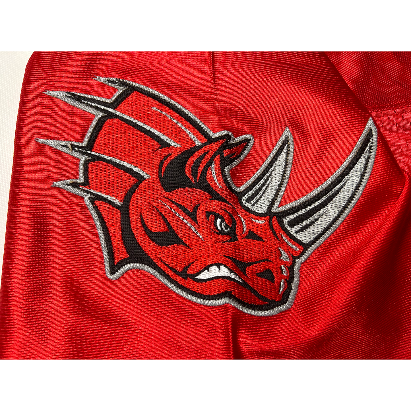 Grand Rapids Rampage Arena Football League jersey. Red. Close-up of charging rhino head with silver tusks. Royal Retros