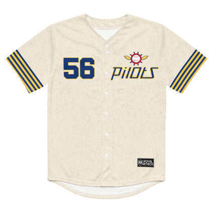 Seattle Pilots button-up short sleeve baseball jersey, cream. 56 on left chest, blue with gold trim. Logo on left chest is captain's wheel, red with gold wings on side. Baseball stitching inside wheel with Pilots in blue in middle. PILOTS below in thin blue letters with gold trim. Alternating thin blue and gold stripes on sleeve ends. Royal Retros.