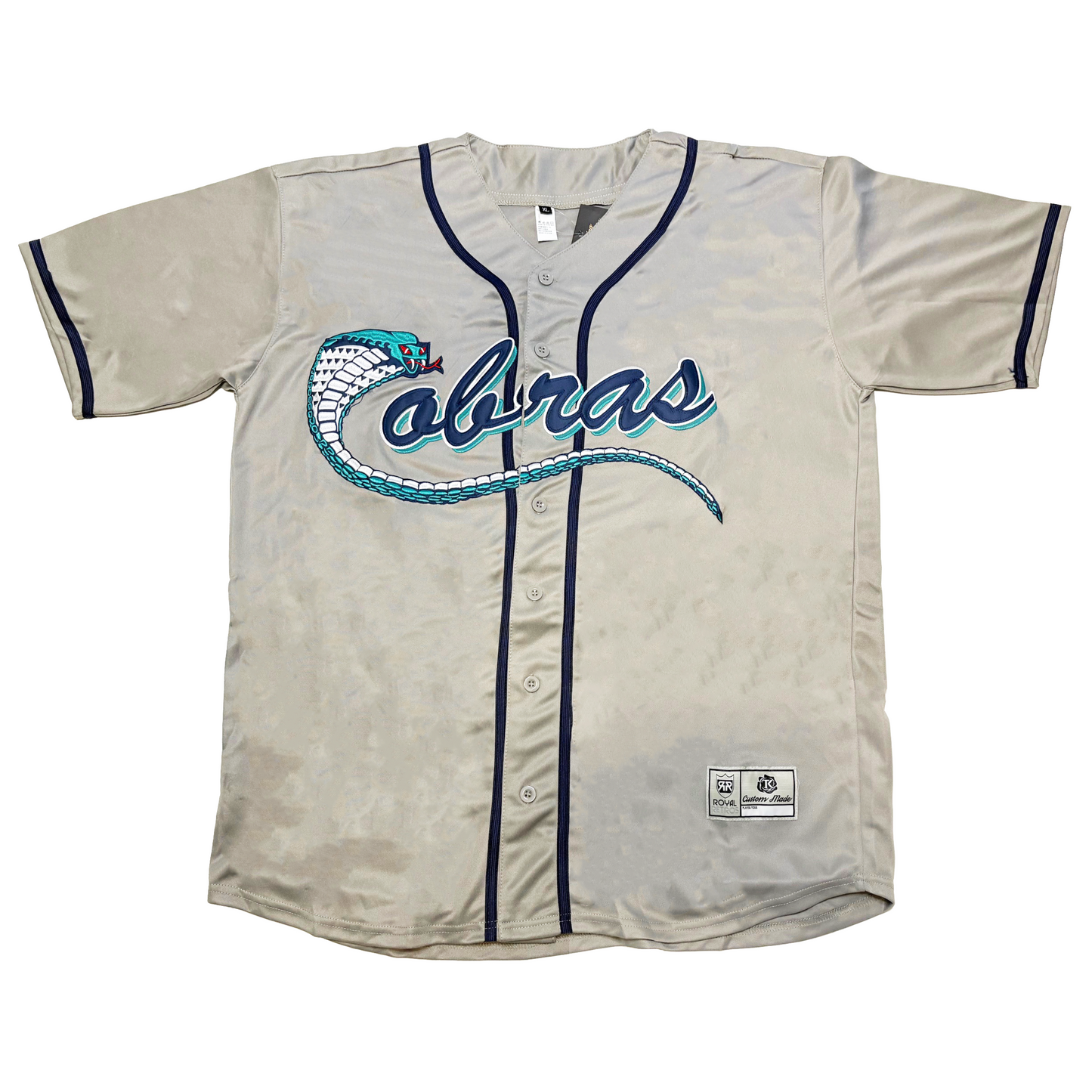 Kissimmee Cobras Jersey - Jerseys. Button-up Gray. Aqua, white, and dark blue cobra forming C with tail underlining rest of logo. Cursive O-B-R-A-S, lower case. Navy piping around neck and down either side of buttons. Navy rings around short-sleeve ends. Royal Retros