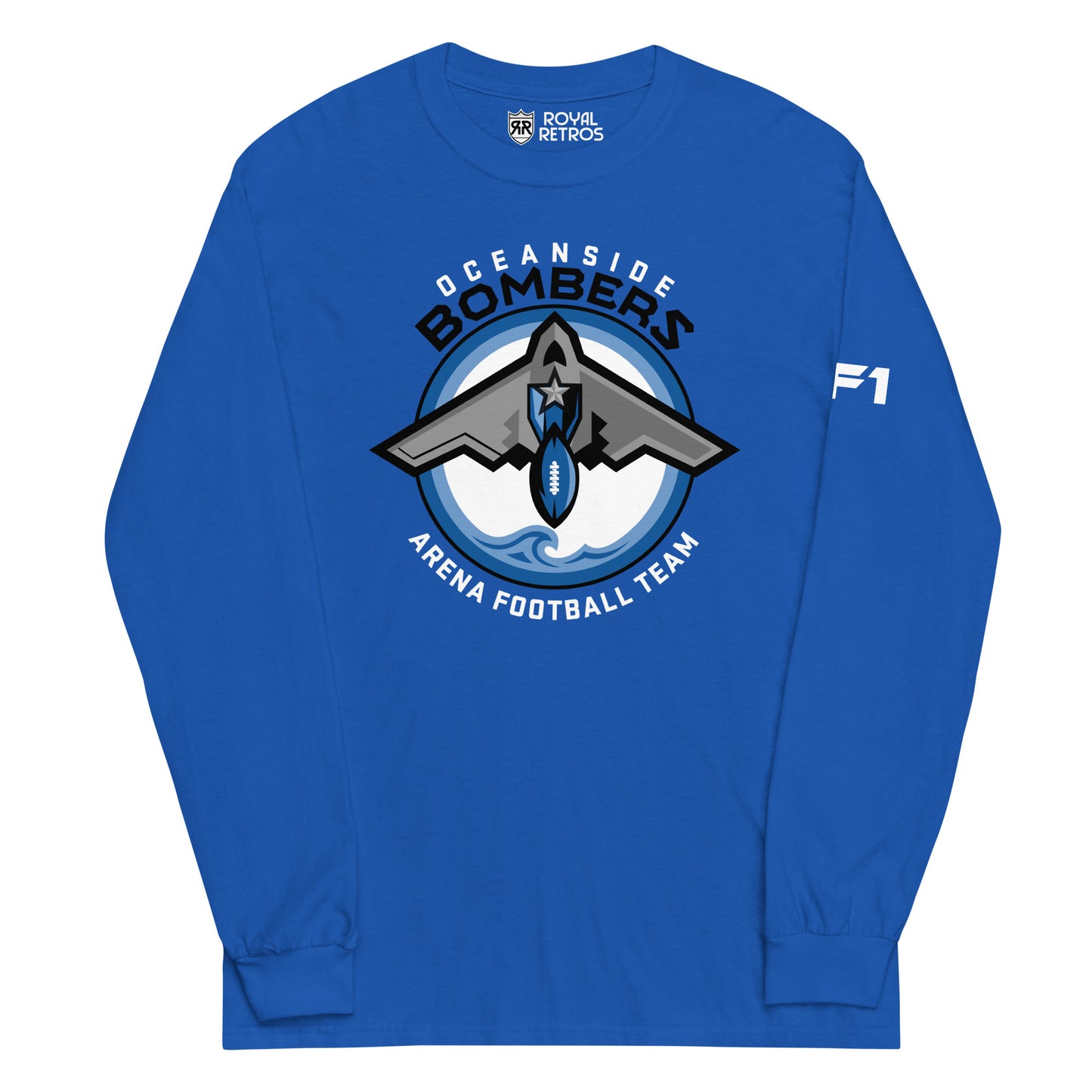 Oceanside Bombers football long sleeve T-shirt. Royal blue. Oceanside in white arched above Bombers slightly larger in black over a circle outlined in black and two slightly larger rings, blue and light blue inside. White background. B-2 bomber from the top over the circle with wings slightly protruding. A football coming off the tail. An ocean wave appears in the bottom of the circle. Outside the circle arched below is Arena Football team arched up in white. Royal Retros