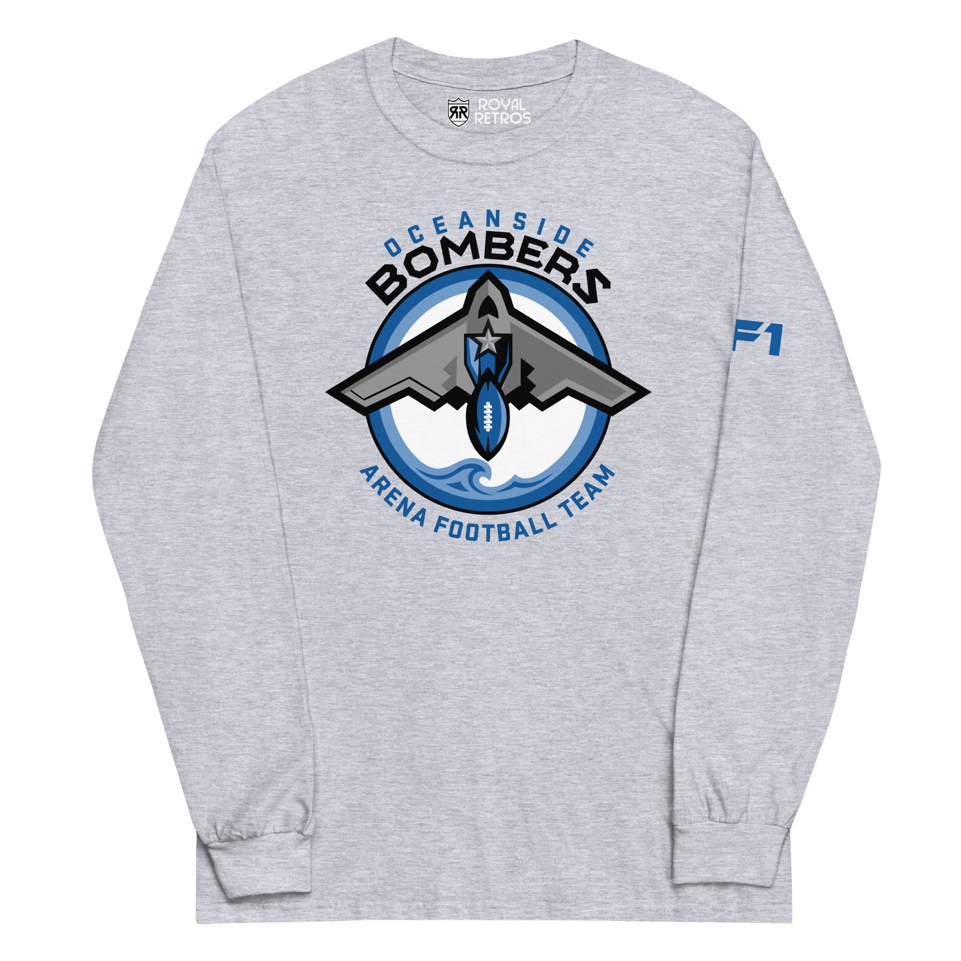 Oceanside Bombers football long sleeve T-shirt. Gray. Oceanside in blue arched above Bombers slightly larger in black over a circle outlined in white and two slightly larger rings, blue and light blue inside. White background. B-2 bomber from the top over the circle with wings slightly protruding. A football coming off the tail. An ocean wave appears in the bottom of the circle. Outside the circle arched below is Arena Football team arched up in blue. Royal Retros