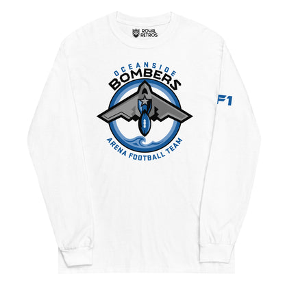 Oceanside Bombers football long sleeve T-shirt. White. Oceanside in blue arched above Bombers slightly larger in black over a circle outlined in white and two slightly larger rings, blue and light blue inside. White background. B-2 bomber from the top over the circle with wings slightly protruding. A football coming off the tail. An ocean wave appears in the bottom of the circle. Outside the circle arched below is Arena Football team arched up in blue. Royal Retros