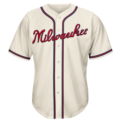 Milwaukee Braves cream jersey. Milwaukee in cursive in red with blue trim across chest. #44 lower right in red with blue trim. Blue, red, and blue stripe around sleeve ends, around neck and down front on both sides of buttons. Royal Retros