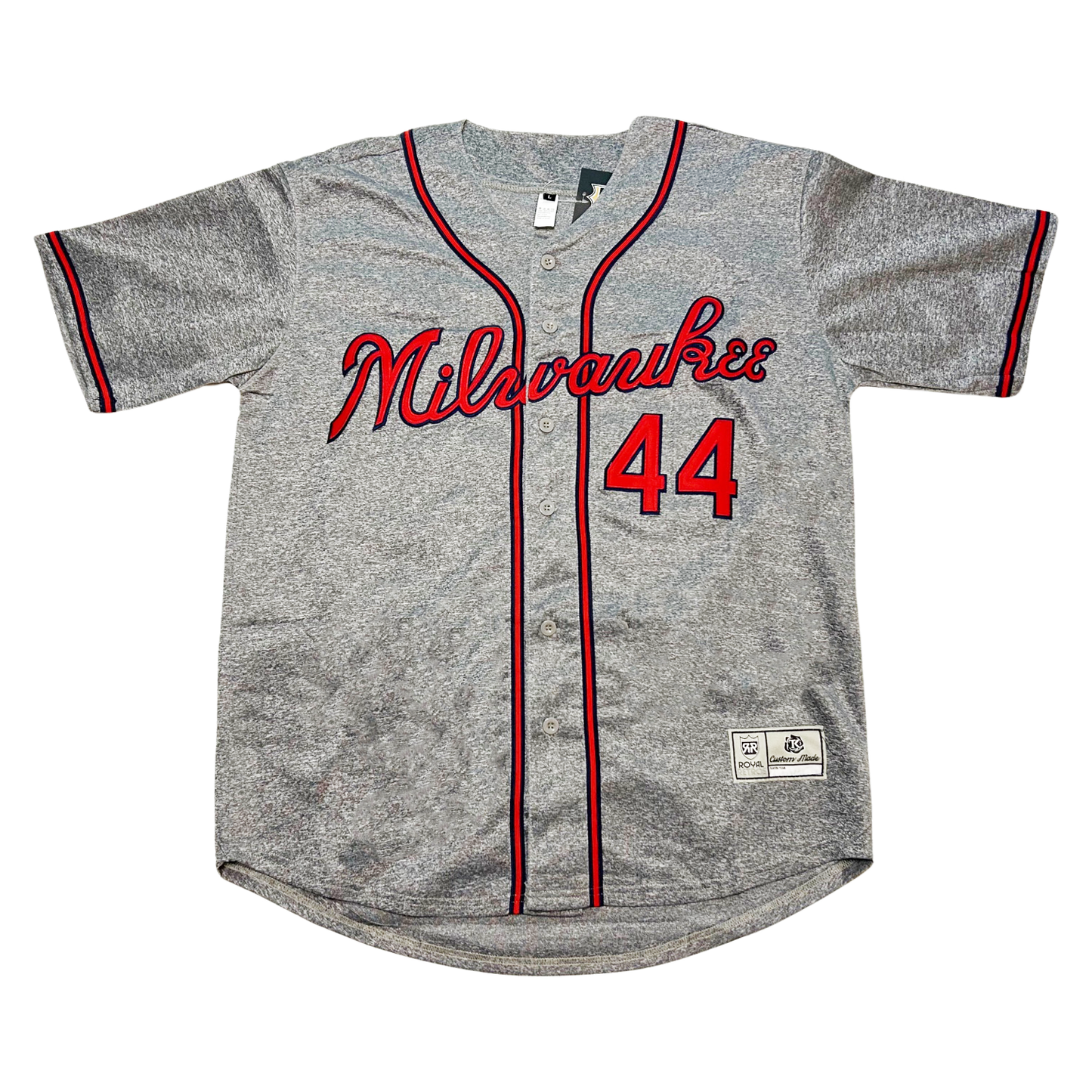 Milwaukee Braves button-up baseball jersey. Pepper gray. Milwaukee in cursive in red with blue trim across chest. #44 lower right in red with blue trim. Blue, red, and blue stripe around sleeve ends, around neck and down front on both sides of buttons. Royal Retros