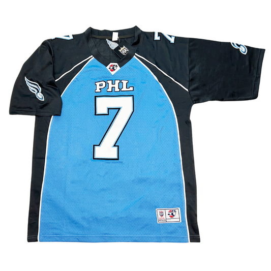 Philadelphia Soul jersey. Light blue front, dark blue side and shoulders. #7 in white with dark blue trim large on chest, small on shoulders. PHL above number on chest in white with dark blue trim. Soul football with streaks logo on sleeves. Royal Retros