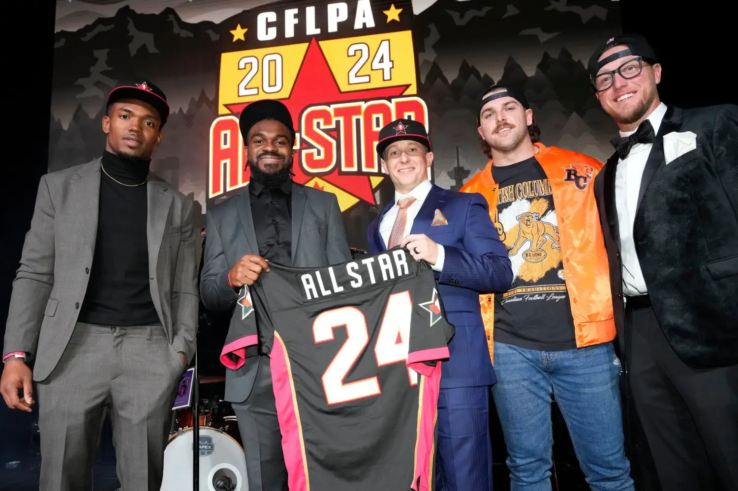 Five CFL players unveiling the custom CFLPA All-Star jersey by Royal Retros at Grey Cup 111