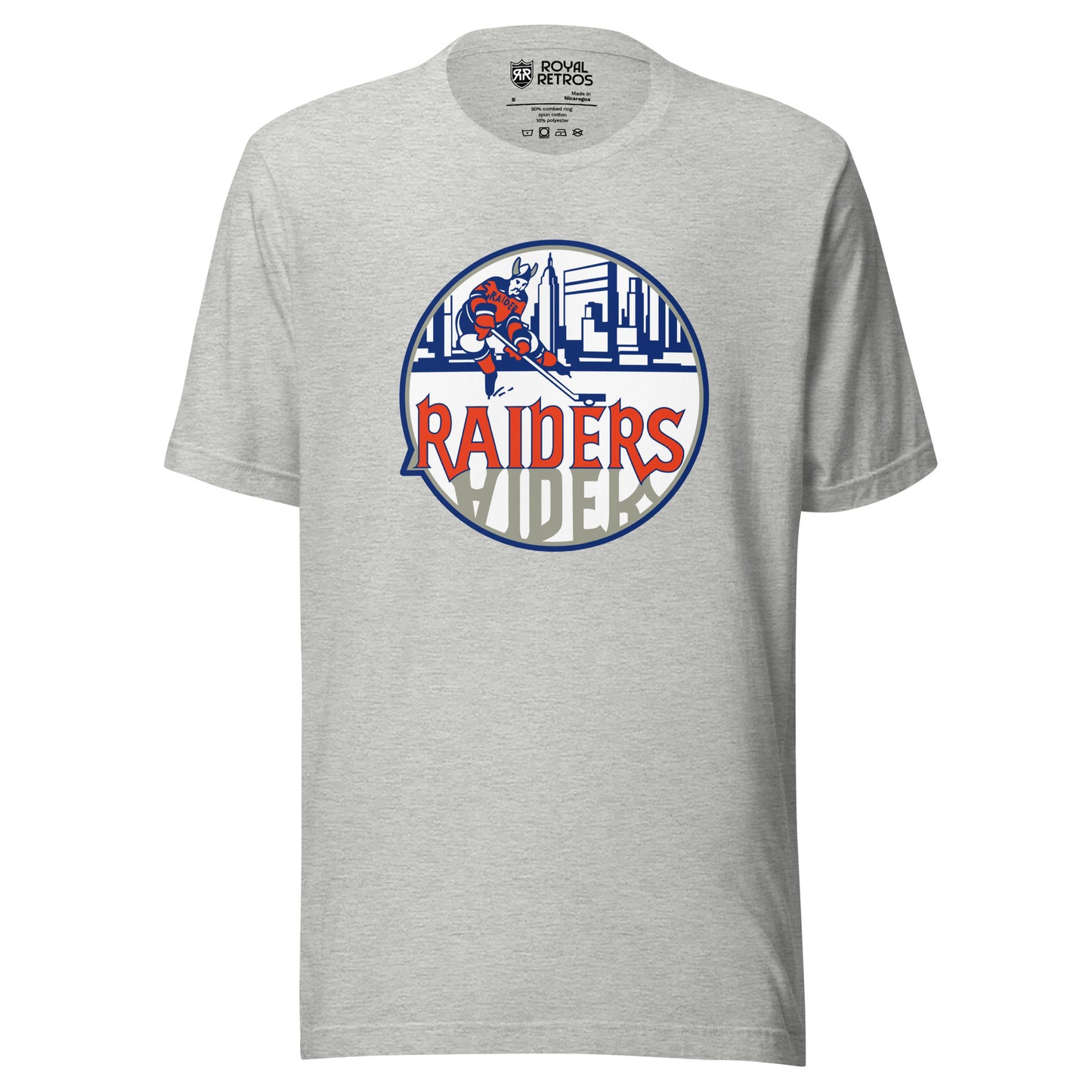 New York Raiders WHA T-shirt. Light Gray. Logo on chest. White circle, with hockey player skating in front of Manhattan Skyline in blue. Raiders in orange below skater, reflected in gray below. Royal Retros