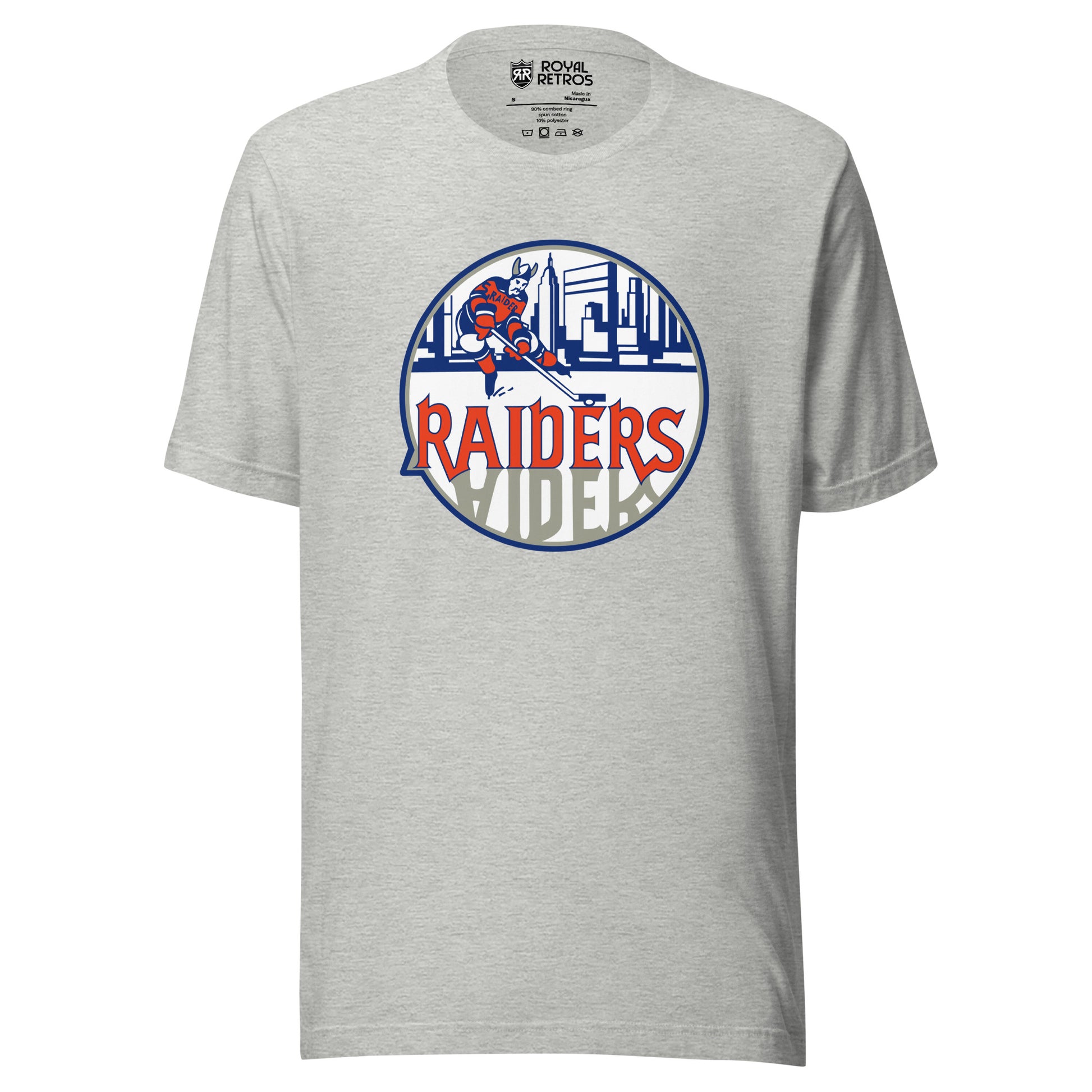 New York Raiders WHA T-shirt. Light Gray. Logo on chest. White circle, with hockey player skating in front of Manhattan Skyline in blue. Raiders in orange below skater, reflected in gray below. Royal Retros