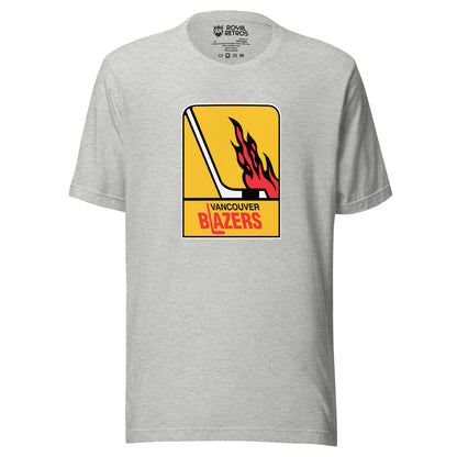 Vancouver WHA T-shirt. Light gray. Logo is vertical gold rectangle. Hockey stick in white facing right. Flames above the blade. Vancouver in black small above Blazers larger in red. L is a hockey stick Royal Retros