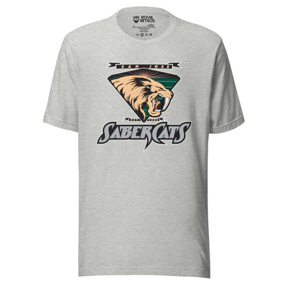 San Jose Sabercats Arena Football League T-shirt gray. San Jose in gold in small black banner, waving at ends, Above upside down triangle shield with sabertooth tiger facing right. Stylized SABERCATS in blue on black background with white trim below. Royal Retros