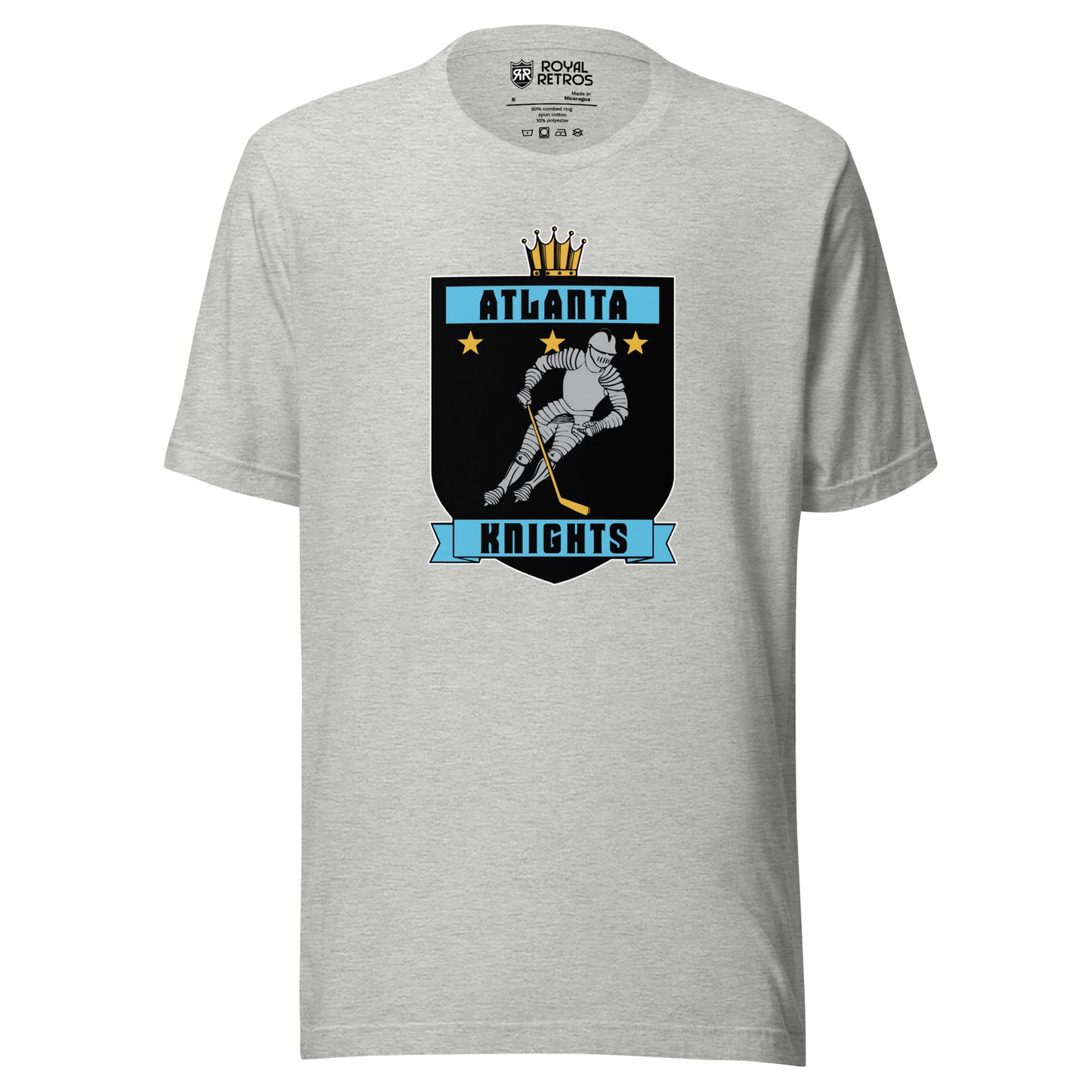 Atlanta Knights hockey T-shirt. Gray. Black shield with small gold crown on top. Blue band inside top with ATLANTA in black. 3 gold stars below that. Knight with hockey stick skating leaning right. Blue banner with Knights below bottom if shield. Royal Retros. 