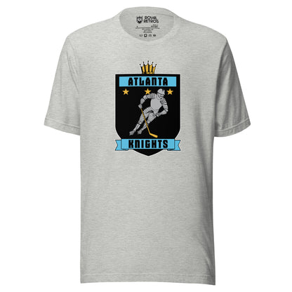 Atlanta Knights hockey T-shirt. Gray. Black shield with small gold crown on top. Blue band inside top with ATLANTA in black. 3 gold stars below that. Knight with hockey stick skating leaning right. Blue banner with Knights below bottom if shield. Royal Retros. 